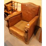 Antique leather arm chair with carved scroll arm supports missing seat cushion