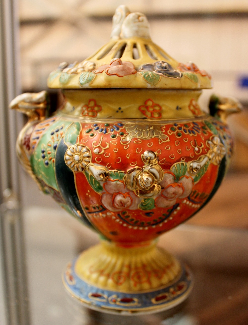 A Japanese censer decorated with flowers and dragon handles with a dog of Foo to the lid