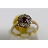 18 ct gold ruby and diamond cluster ring,