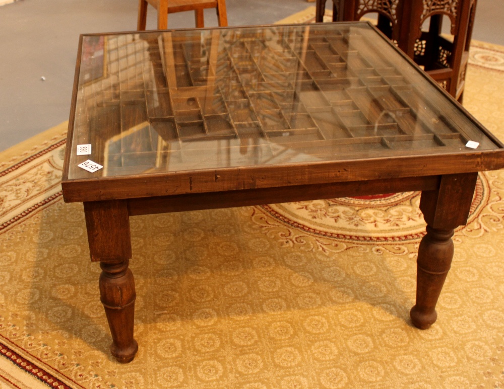 Stained pine glass topped coffee table with intricate design,