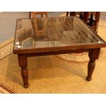 Stained pine glass topped coffee table with intricate design,