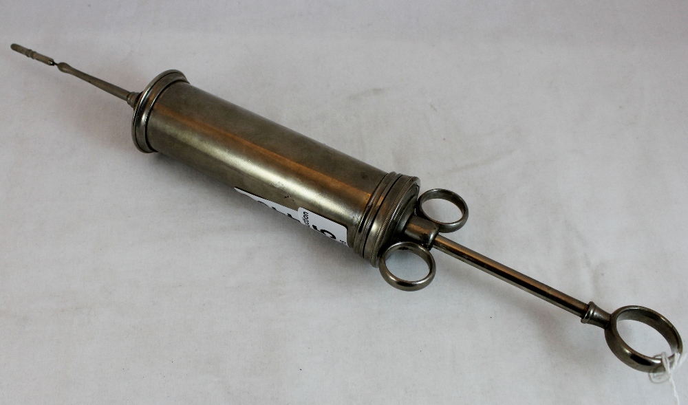 Antique white metal medical syringe