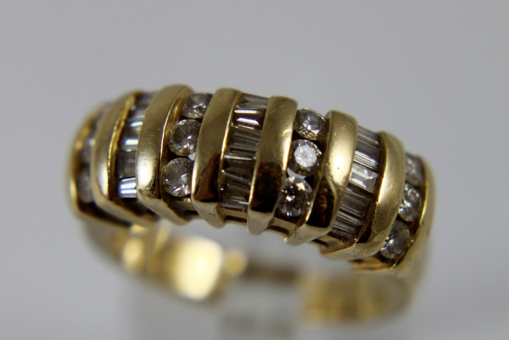 14 K stamped yellow gold ring set with round and baguette cut diamonds