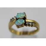 9 ct gold ring with two fire opals and six small white stones