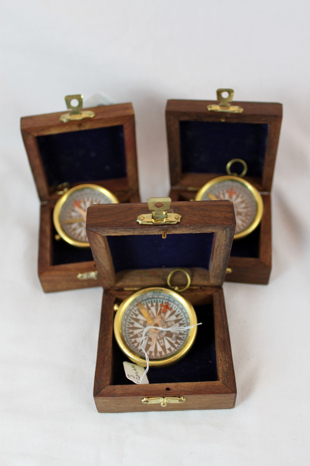 Three reproduction brass compass