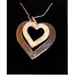 White metal necklace with a white metal pendant in the shape of two hearts