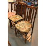 Four matching spindle back dining chairs with cushions