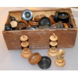 Box of carved wood chess and draught pieces