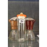 Two bakelite creamers and a mixer