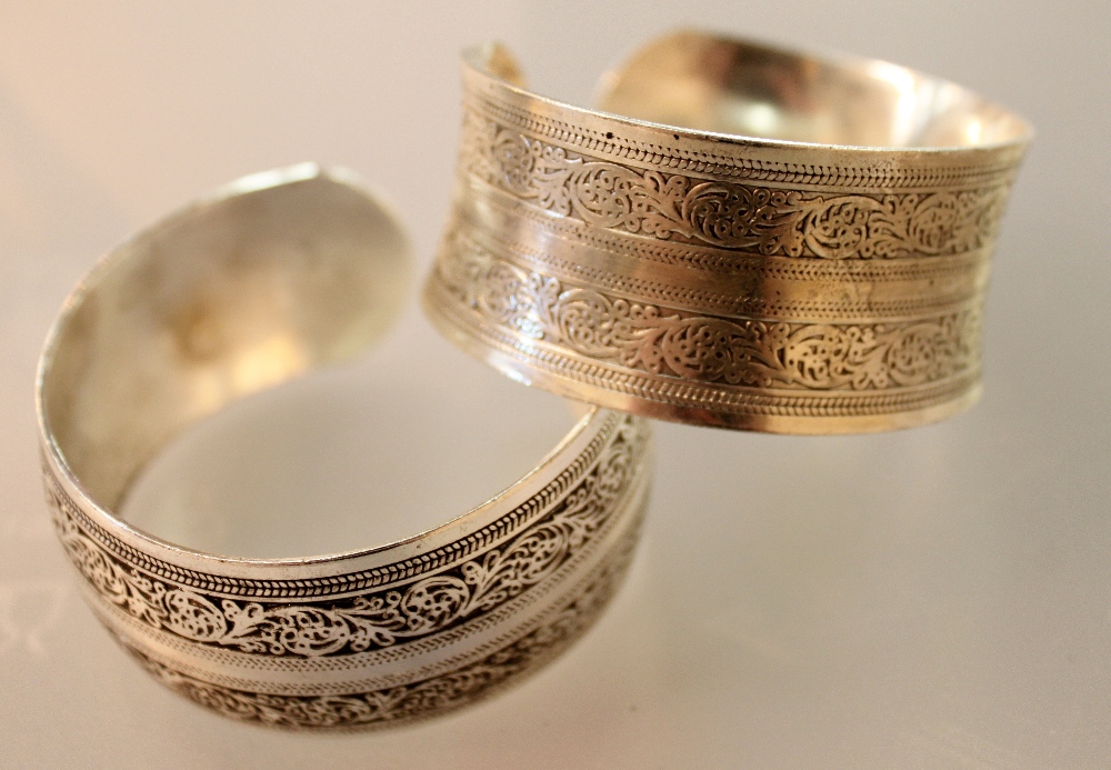 Pair of heavy white metal bracelets