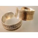 Pair of heavy white metal bracelets