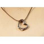 White metal necklace with a white metal heart shaped pendant with CZ