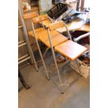 Three metal and wooden foldout bar stools