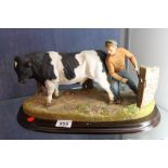 Country Artist standing four square Holstein bull figure,