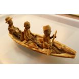 Unusual carved wooden ornament of three people sailing