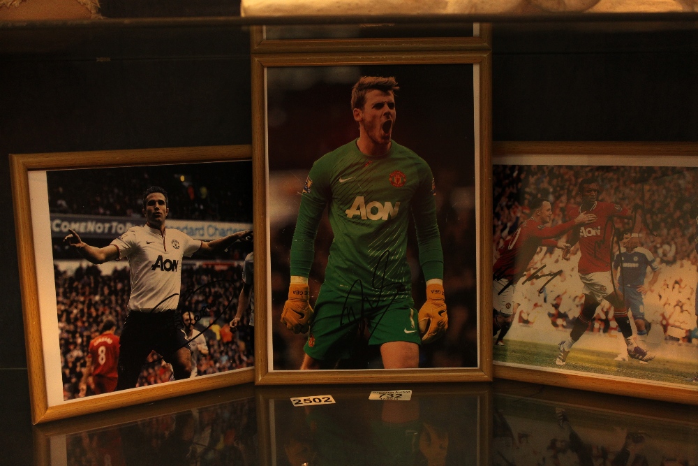 Three framed pictures/prints of Manchester United players all with a signature,