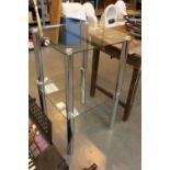 Pair of glass topped coffee tables on four chrome supports