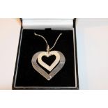 White metal necklace with a white metal pendant in the shape of two hearts