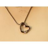 White metal necklace with a white metal heart shaped pendant with CZ