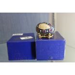 Two boxed decorative Faberge style eggs