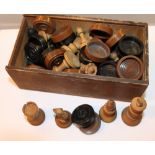 Box of carved wood chess and draught pieces