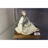 Seated Nao figure on wooden plinth