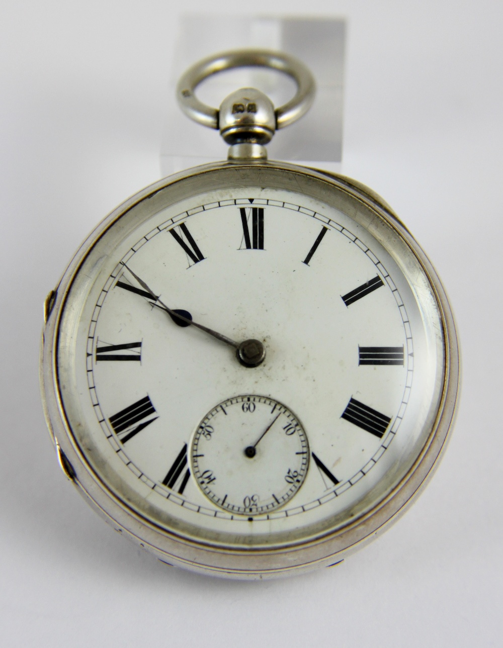 Hallmarked silver open face key wind pocket watch with roman numerals.