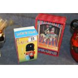 Boxed musical dancing clown and tin plate drummer