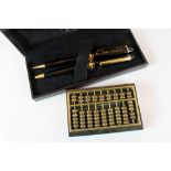 Remy Martin pen set and brass abacus on marble stand