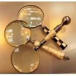Three mother of pearl handled magnifying glasses