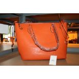 Orange leather ladies handbag with matching purse