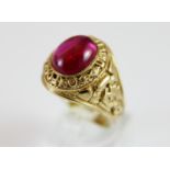 9 ct gold American style college ring set with red cabachon stone,