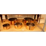 Set of five French copper pans and pan rack