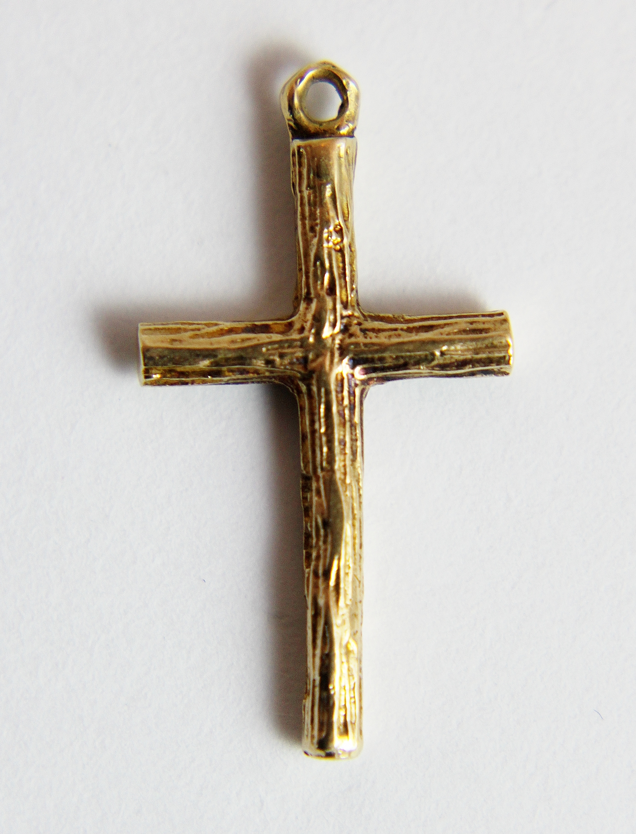 9 ct gold small bark effect cross.