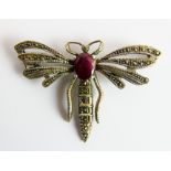 Silver dragonfly brooch set with a large ruby. Wingspan 6 cm.