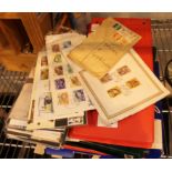 Three albums and a quantity of loose first day issue postage stamps