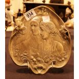 Art Nouveau decorative metal plate depicting two ladies