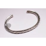 Silver solid torq bangle.