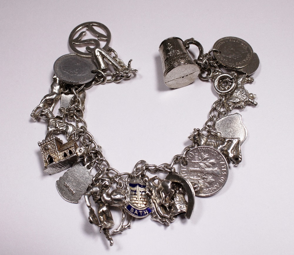 Silver charm bracelet with 18 charms,