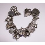 Silver charm bracelet with 18 charms,