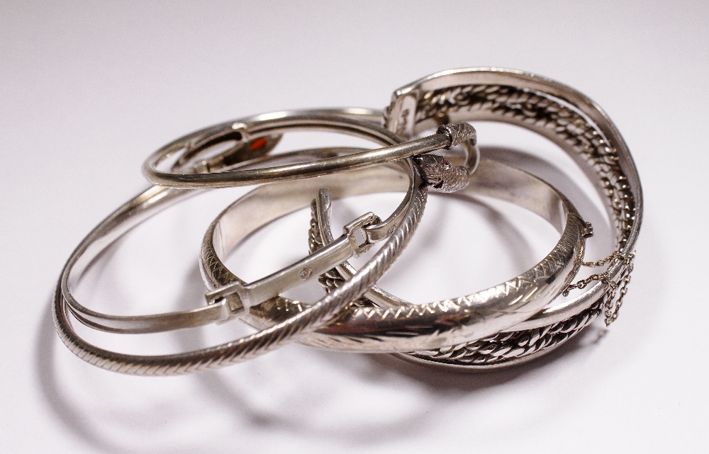 Five silver bangles,