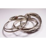 Five silver bangles,