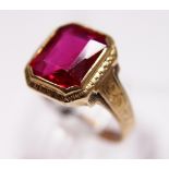 Gents red stone set ring marked 10KT to shank, size Q. 3.