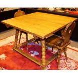 Stained Austrian pine square dining table with bobbin turned legs and two Austrian dining chairs