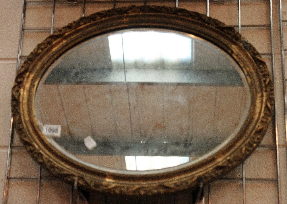 Gilt plaster framed bevel edged oval wall mirror