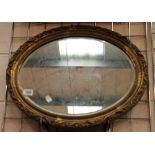 Gilt plaster framed bevel edged oval wall mirror