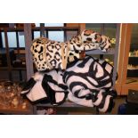 Seven synthetic fur throws in animal skin designs, two leopard, three cow and two zebra.