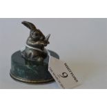 An unusual Russian paperweight in the form of a rabbit clutching a carrot on agate base. Est. £350 -