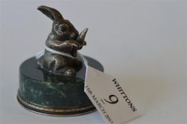 An unusual Russian paperweight in the form of a rabbit clutching a carrot on agate base. Est. £350 -