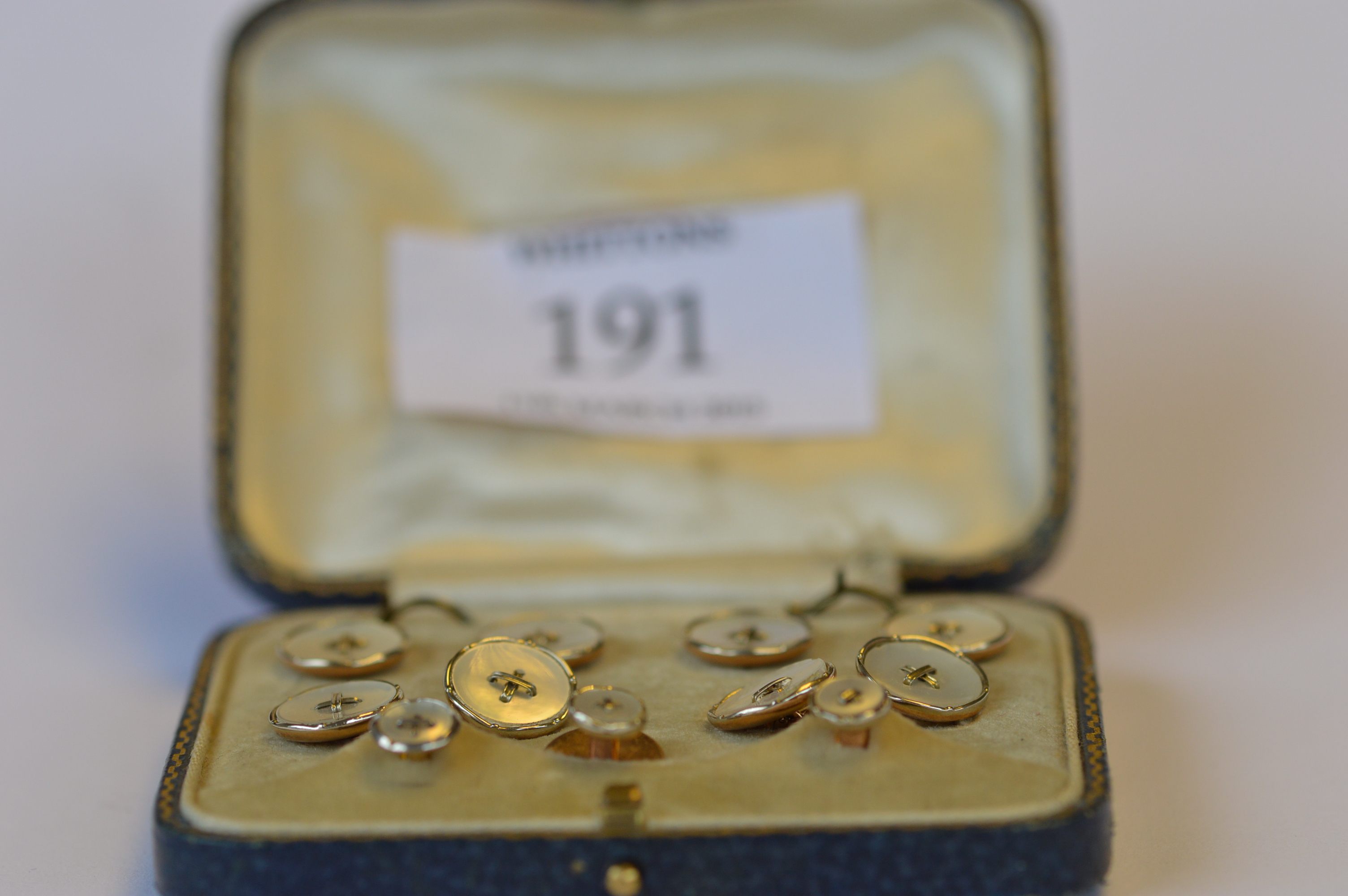 A good boxed set of 18ct and platinum mother of pearl cufflinks and buttons in fitted velvet case.